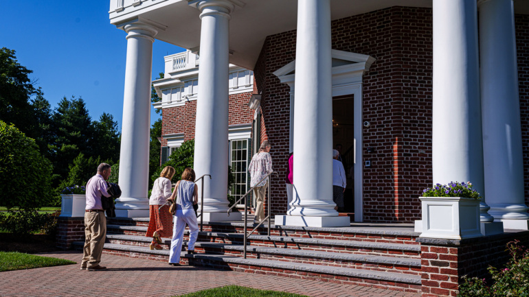 A group of people walking up the stairs of a building