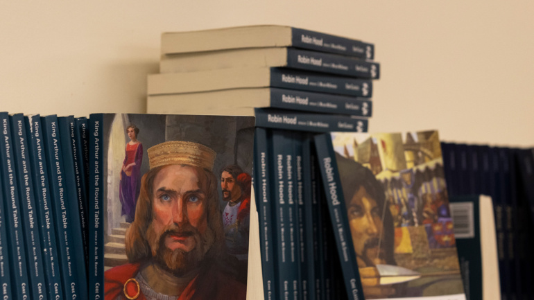 King Arthur and the Roundtable is displayed on a bookshelf.