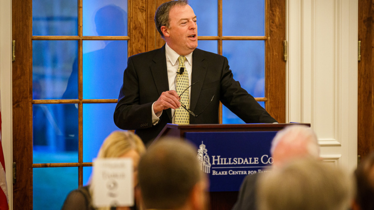 Dr. Matt Spaulding speaking at a podium.